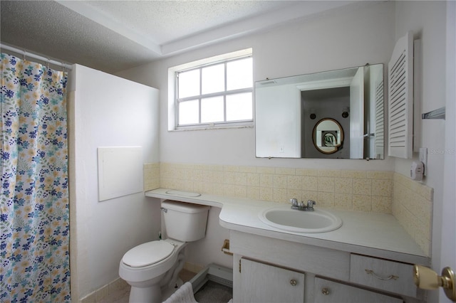 bathroom with a textured ceiling, toilet, vanity, and backsplash