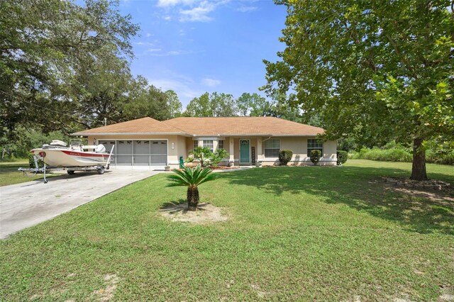 single story home with a garage and a front lawn