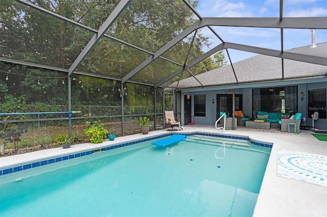 view of swimming pool featuring a lanai, a patio, and an outdoor living space