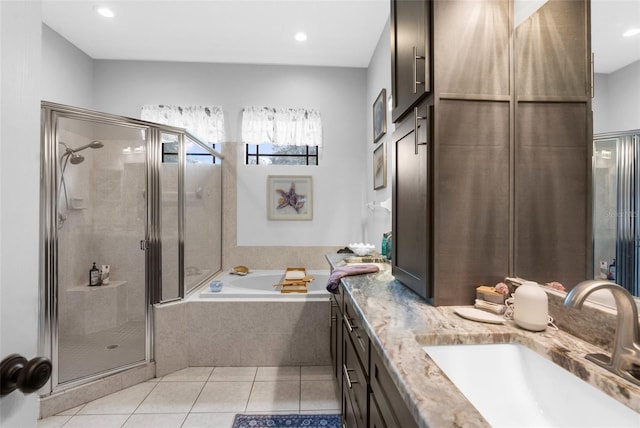 bathroom featuring dual vanity, plus walk in shower, and tile patterned floors