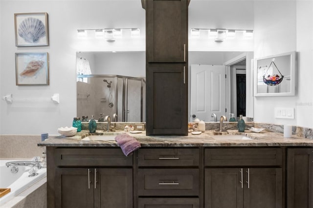 bathroom with double sink vanity and separate shower and tub