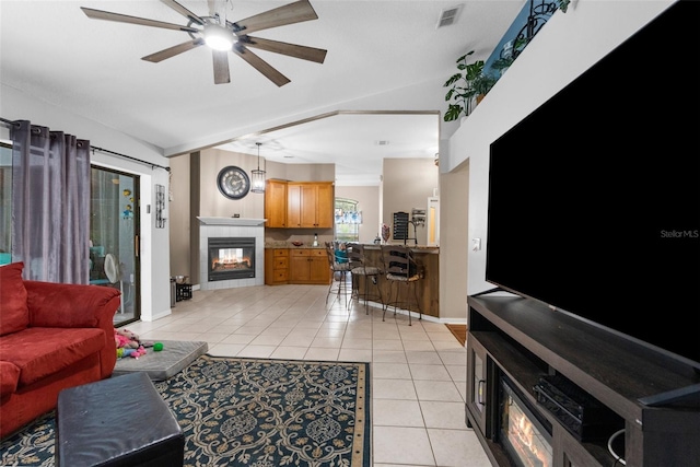 tiled living room with ceiling fan