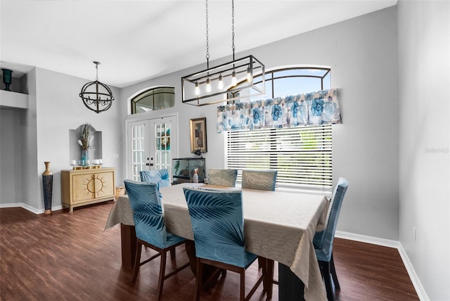 dining area with a notable chandelier, french doors, and dark hardwood / wood-style flooring