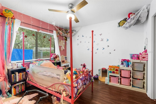 bedroom with ceiling fan, multiple windows, and hardwood / wood-style flooring