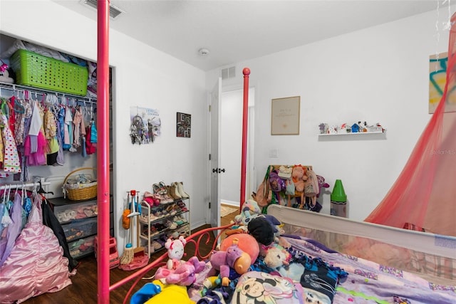 bedroom with wood-type flooring and a closet