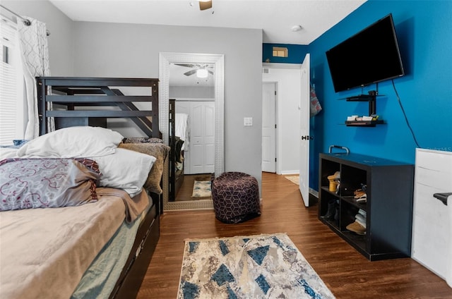 bedroom featuring ceiling fan, dark hardwood / wood-style flooring, and a closet