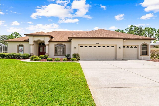 view of front of home featuring a garage and a front yard