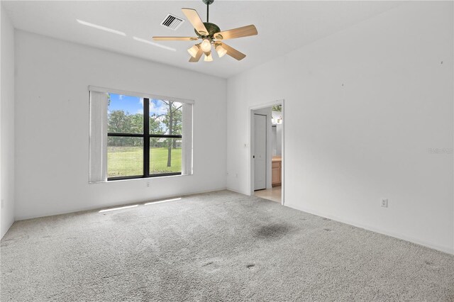 carpeted spare room featuring ceiling fan