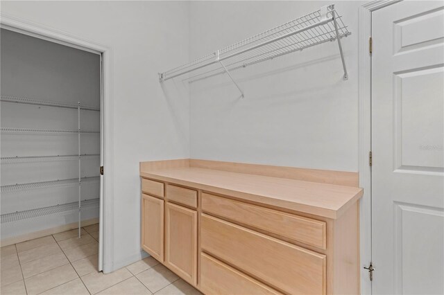 spacious closet with light tile patterned flooring