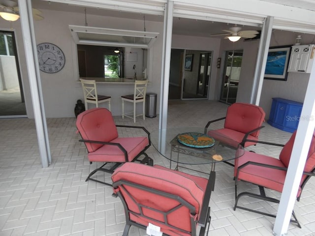 view of patio / terrace with ceiling fan and an outdoor living space