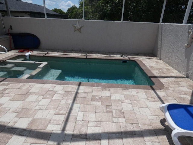 view of pool with a patio and a lanai