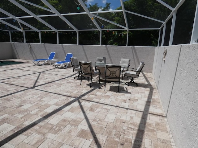 view of patio featuring a lanai