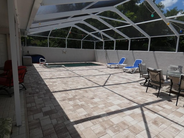 view of patio / terrace with glass enclosure and a fenced in pool