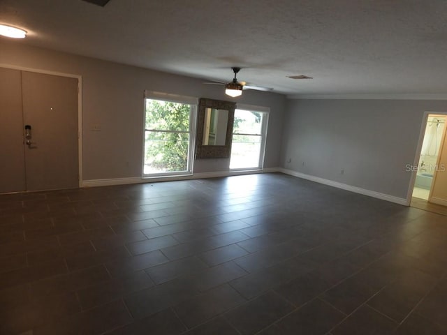 tiled spare room featuring ceiling fan and crown molding