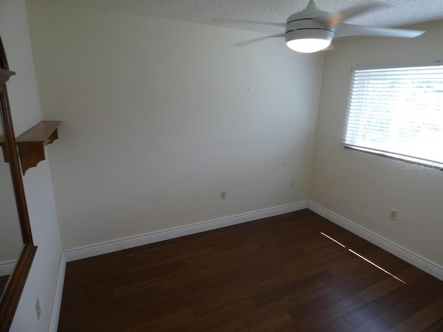 empty room with a textured ceiling, ceiling fan, and wood-type flooring