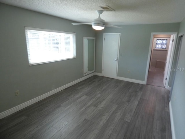 interior space with a textured ceiling, a closet, ceiling fan, and wood-type flooring