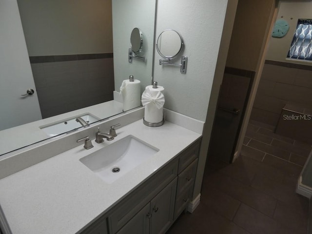 bathroom featuring tile patterned flooring and vanity