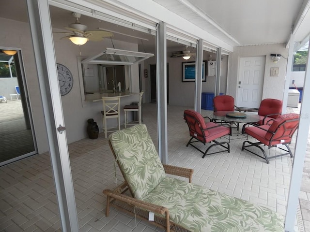 sunroom / solarium featuring sink and ceiling fan