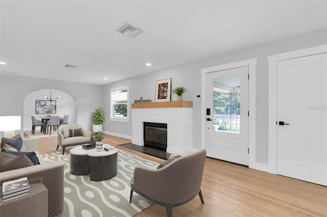 living room featuring a wealth of natural light and light hardwood / wood-style floors