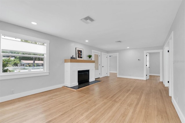 unfurnished living room featuring light hardwood / wood-style floors