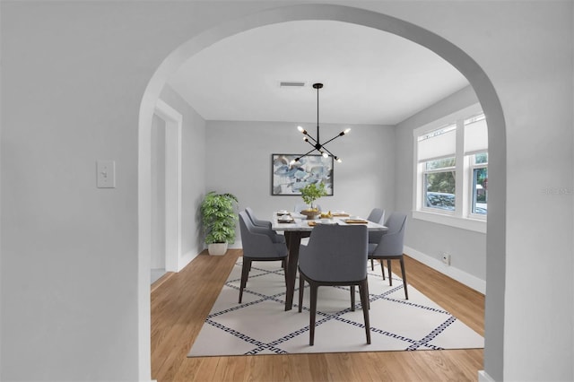 dining space featuring a chandelier and light hardwood / wood-style flooring