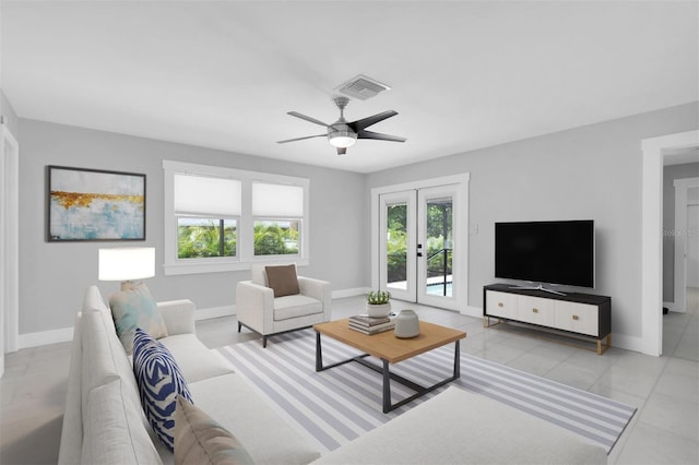 tiled living room with ceiling fan, french doors, and a healthy amount of sunlight