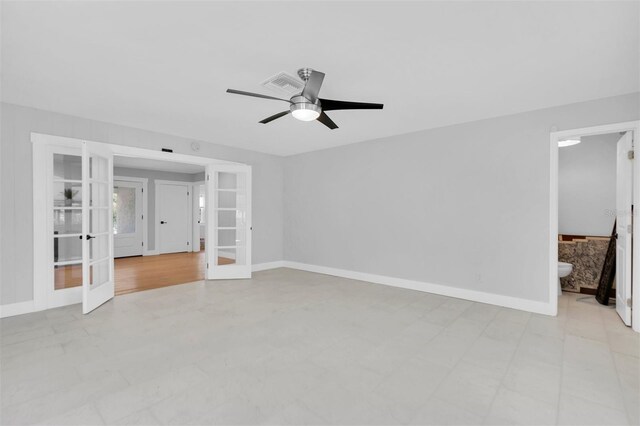 empty room with light tile patterned flooring, french doors, and ceiling fan