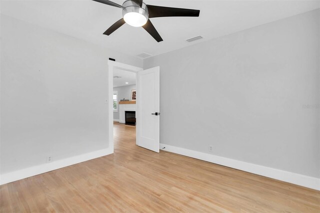 spare room featuring ceiling fan and light wood-type flooring