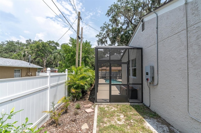 view of yard with glass enclosure