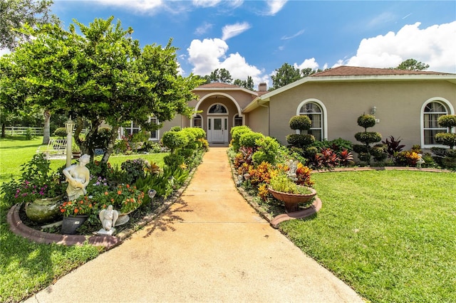 mediterranean / spanish-style home featuring a front yard