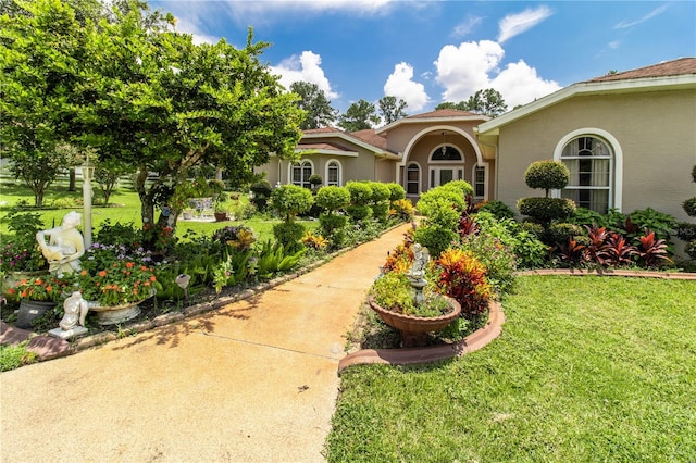 mediterranean / spanish-style home featuring a front yard