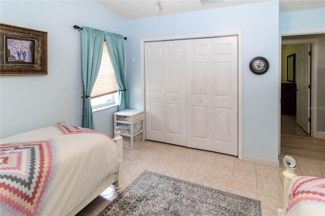 bedroom with light tile patterned floors and a closet