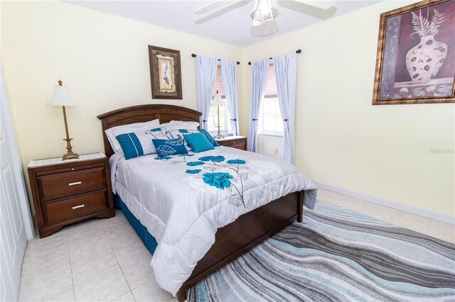 bedroom with ceiling fan and light tile patterned flooring