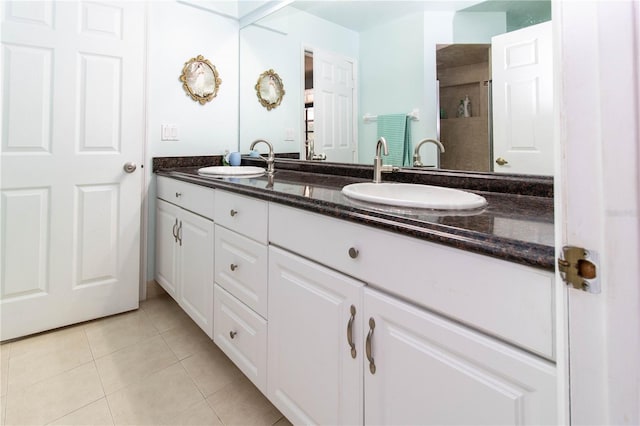 bathroom with tile patterned floors and dual vanity