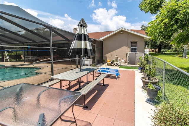 view of swimming pool with a patio area, a lanai, and a lawn