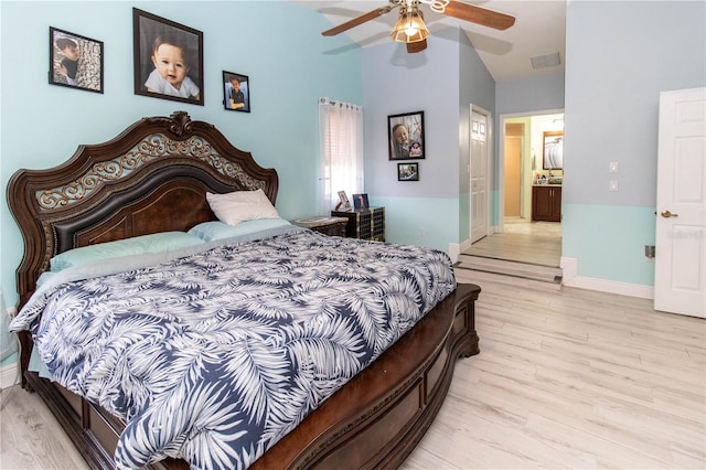 bedroom with ceiling fan, light wood-type flooring, a closet, and connected bathroom