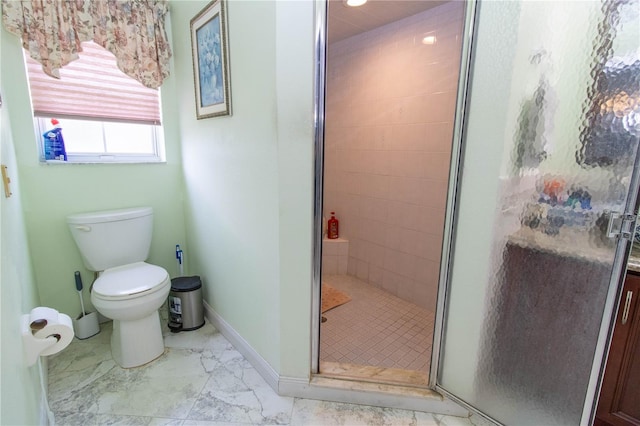 bathroom with a shower with door, toilet, and tile patterned floors