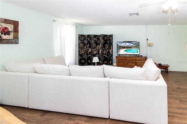 living room featuring ceiling fan and hardwood / wood-style flooring