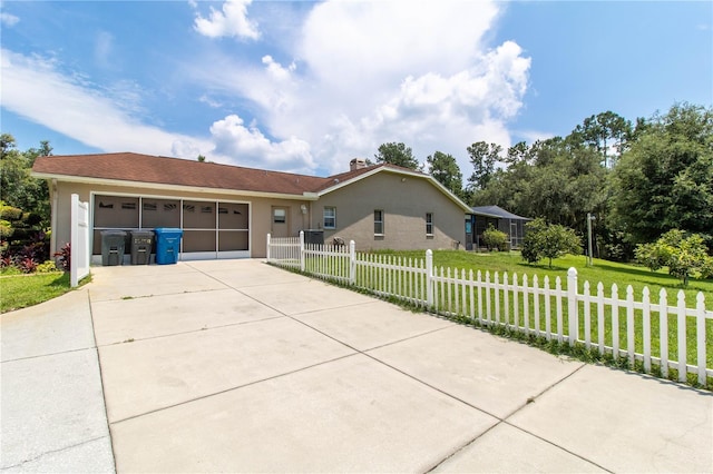 ranch-style home featuring a garage and a front yard