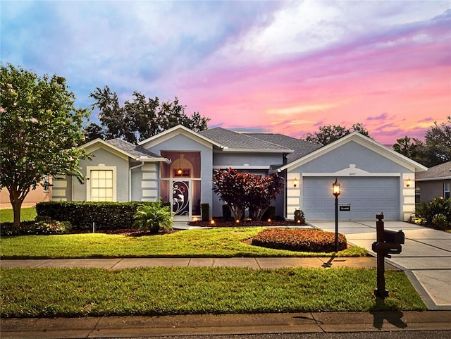 ranch-style home with a yard and a garage