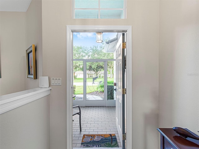 doorway with tile patterned flooring