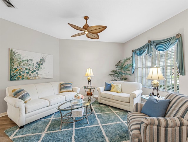 living room featuring ceiling fan and hardwood / wood-style floors