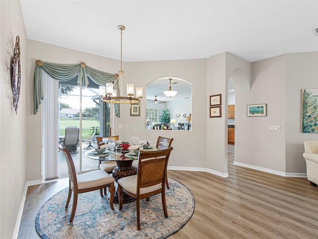 dining area with hardwood / wood-style floors and a notable chandelier