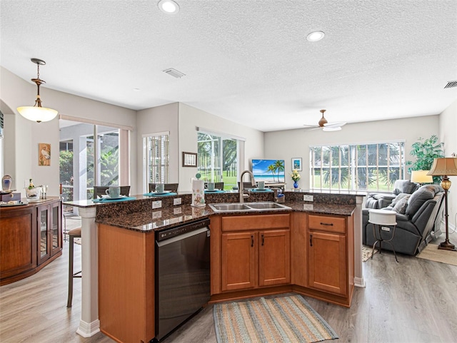 kitchen with black dishwasher, plenty of natural light, and sink