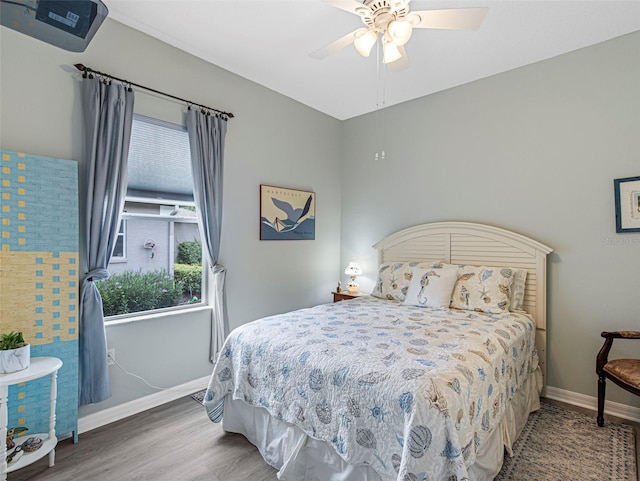 bedroom with ceiling fan and hardwood / wood-style floors