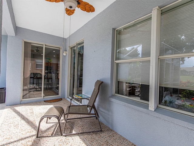 sunroom featuring ceiling fan