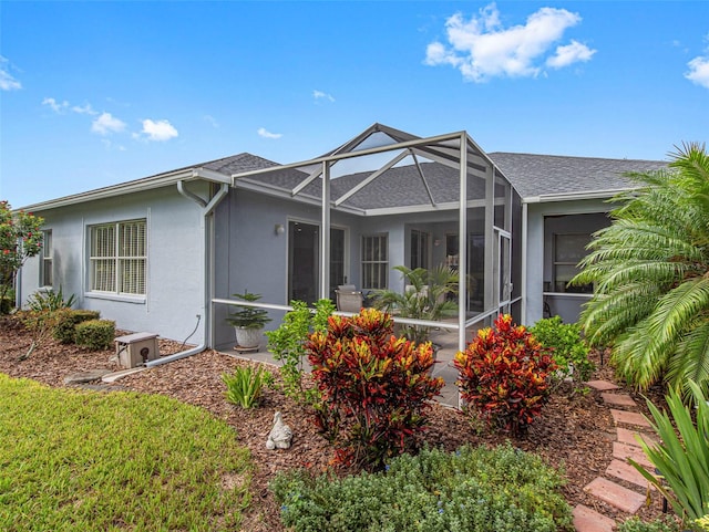 rear view of property with glass enclosure