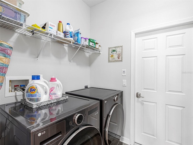 laundry area with washing machine and dryer