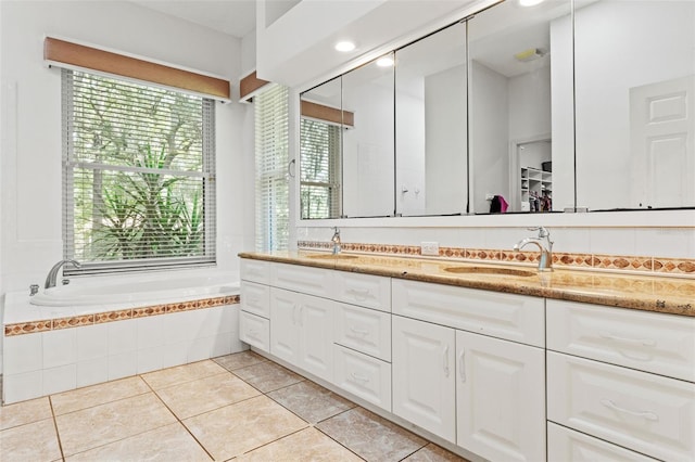 full bath featuring double vanity, tile patterned flooring, a sink, and a bath