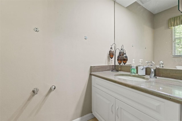 bathroom featuring baseboards and vanity